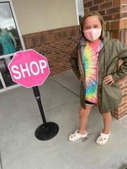 Young child standing next to stop-sign