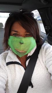 Woman with grinch facemask and white top