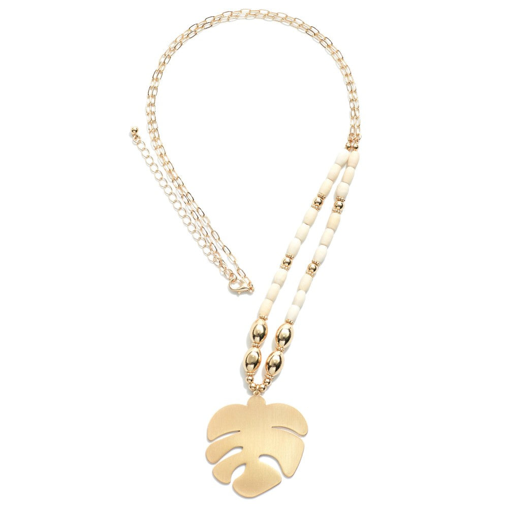 Long Gold tone chain with gold beads and Ivory wood beads with palm leaf pendant