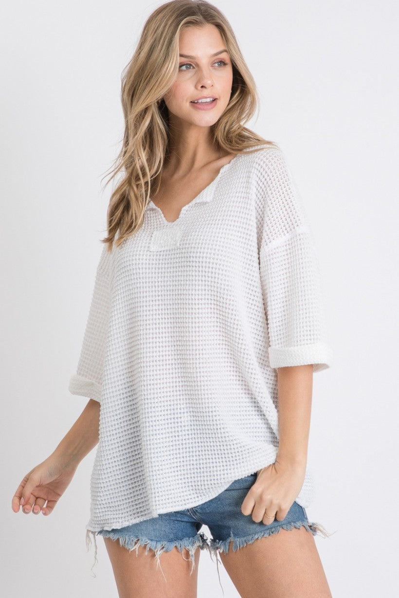 Solid waffle knit top with reverse stitch details